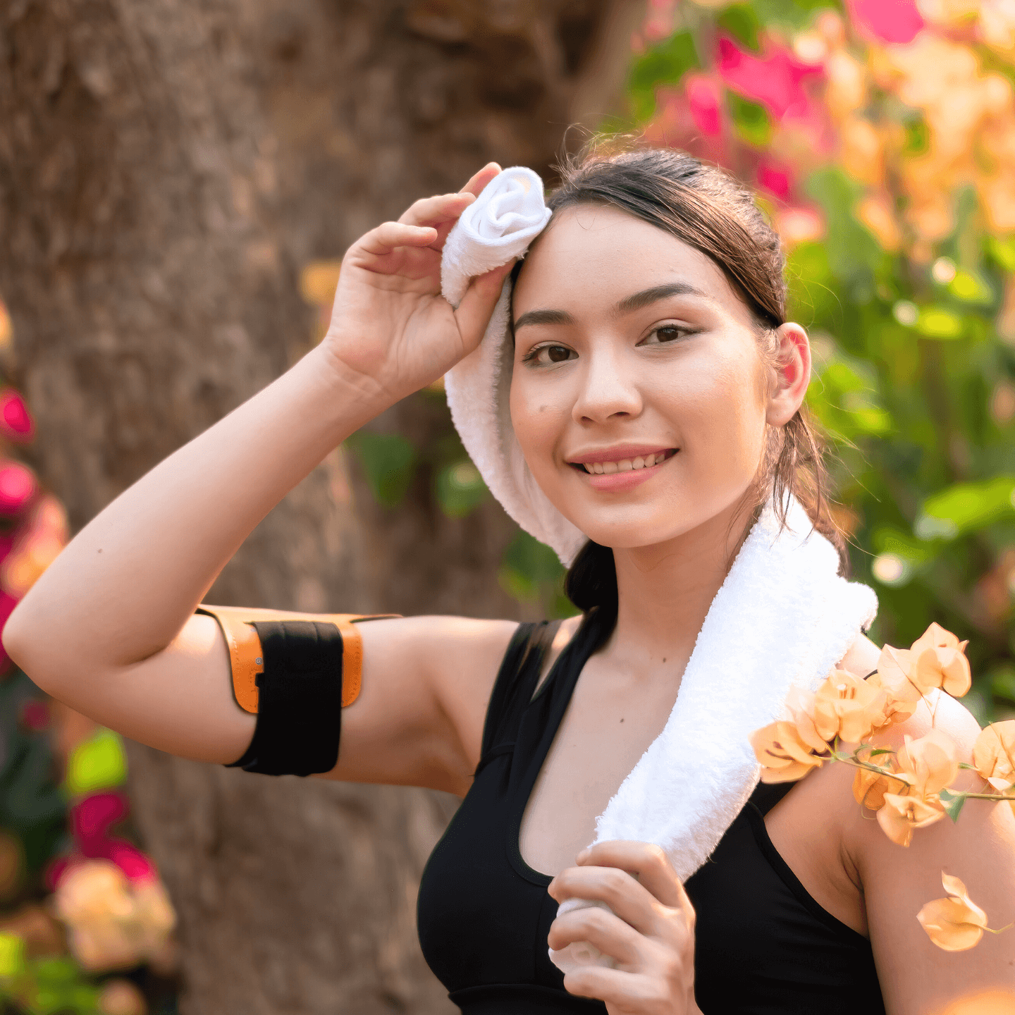 fitness enthusiast wiping sweat from her face after exercising